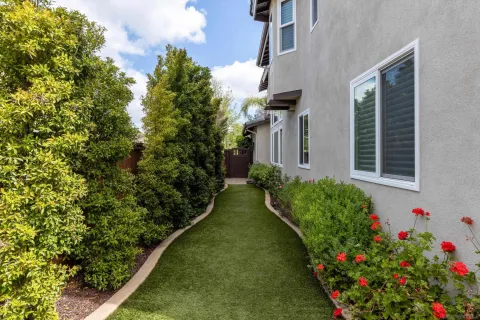 a flower garden in front of a house