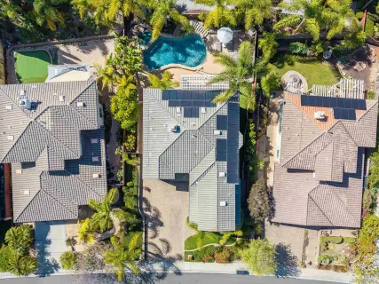 an aerial view of a house with a yard and garden
