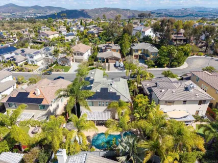 an aerial view of residential houses with outdoor space