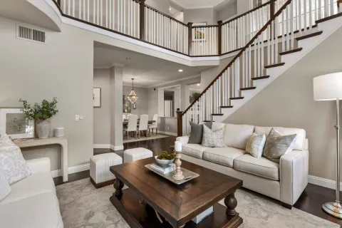 a living room with furniture and a dining table