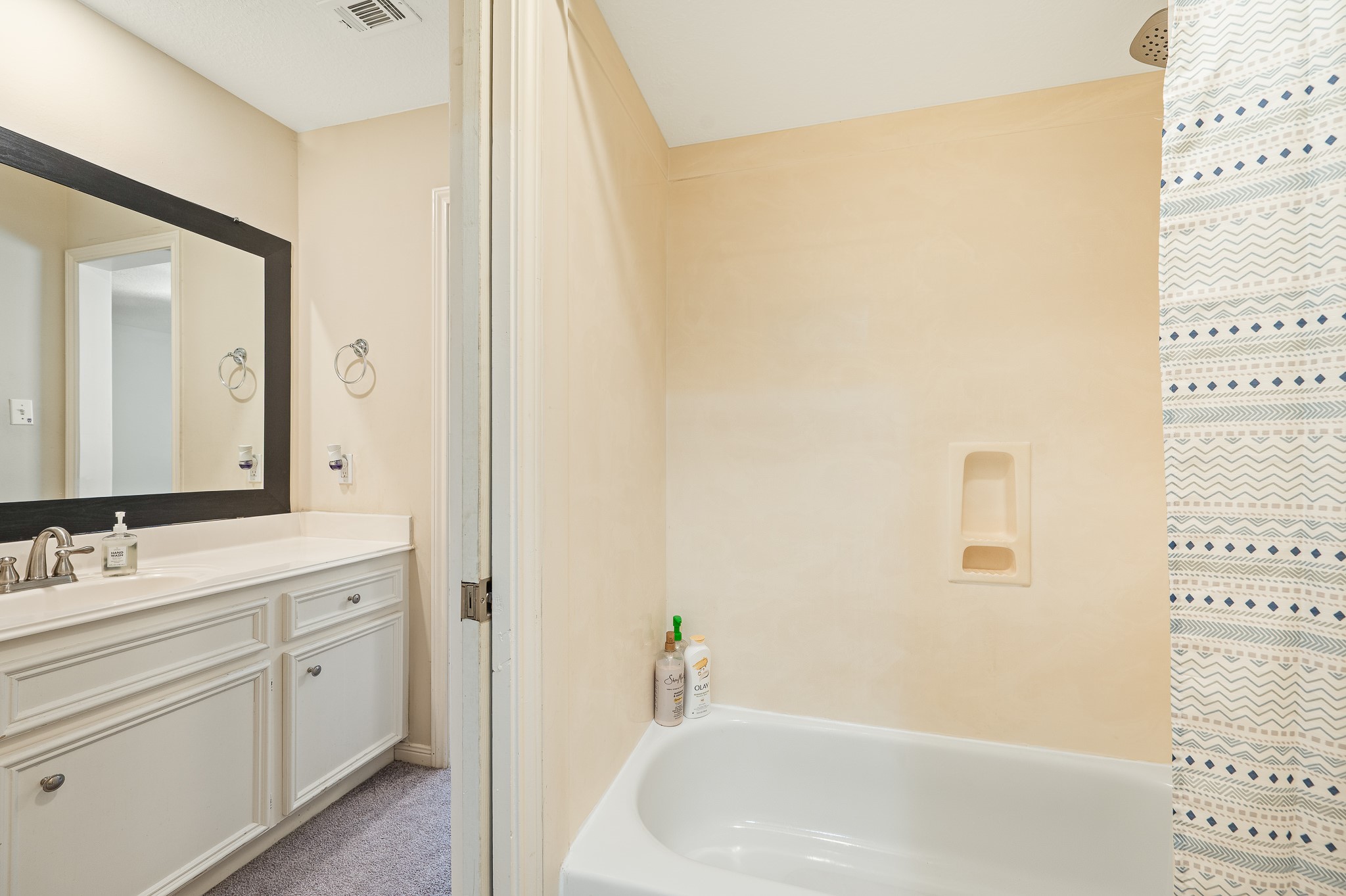 8111 Morningbrook Court Spring, TX 77379 - Photo 31 of 46 a bathroom with a bathtub sink vanity and mirror