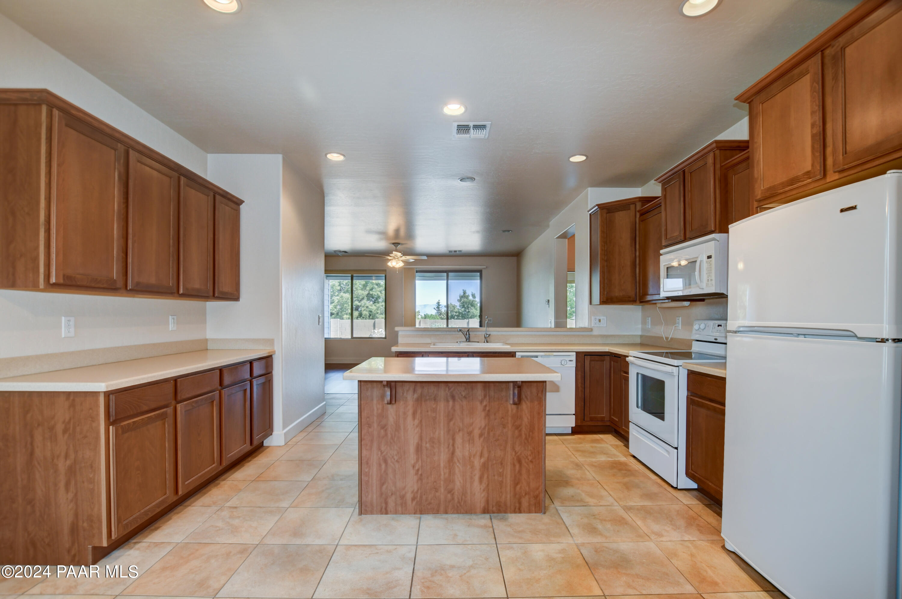 1147 Rusty Nail Road Prescott Valley, AZ 86314 - Photo 11 of 50 a kitchen with stainless steel appliances granite countertop a stove top oven a sink a counter top space and cabinets