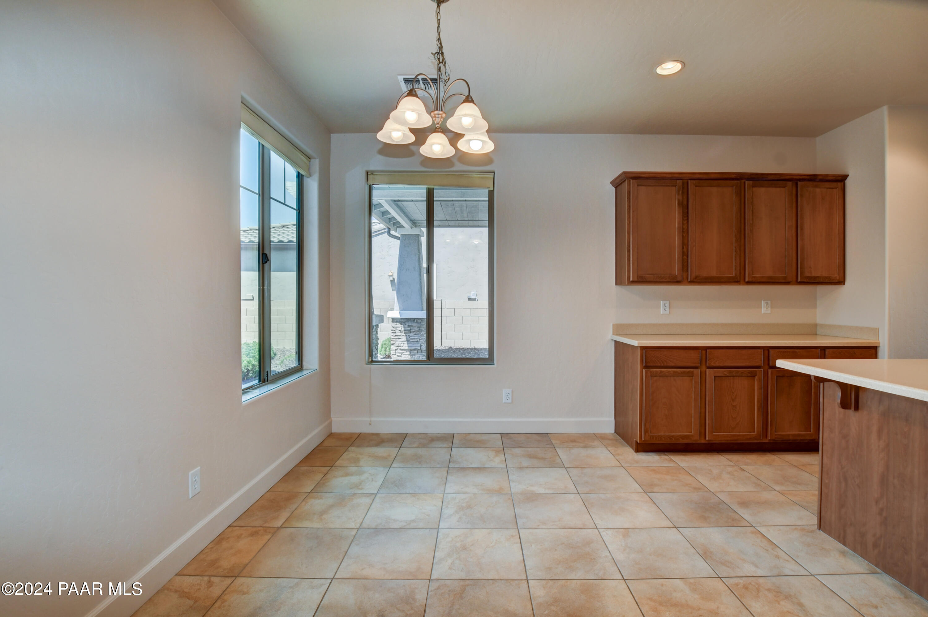 1147 Rusty Nail Road Prescott Valley, AZ 86314 - Photo 13 of 50 a view of an empty room with a window and kitchen area