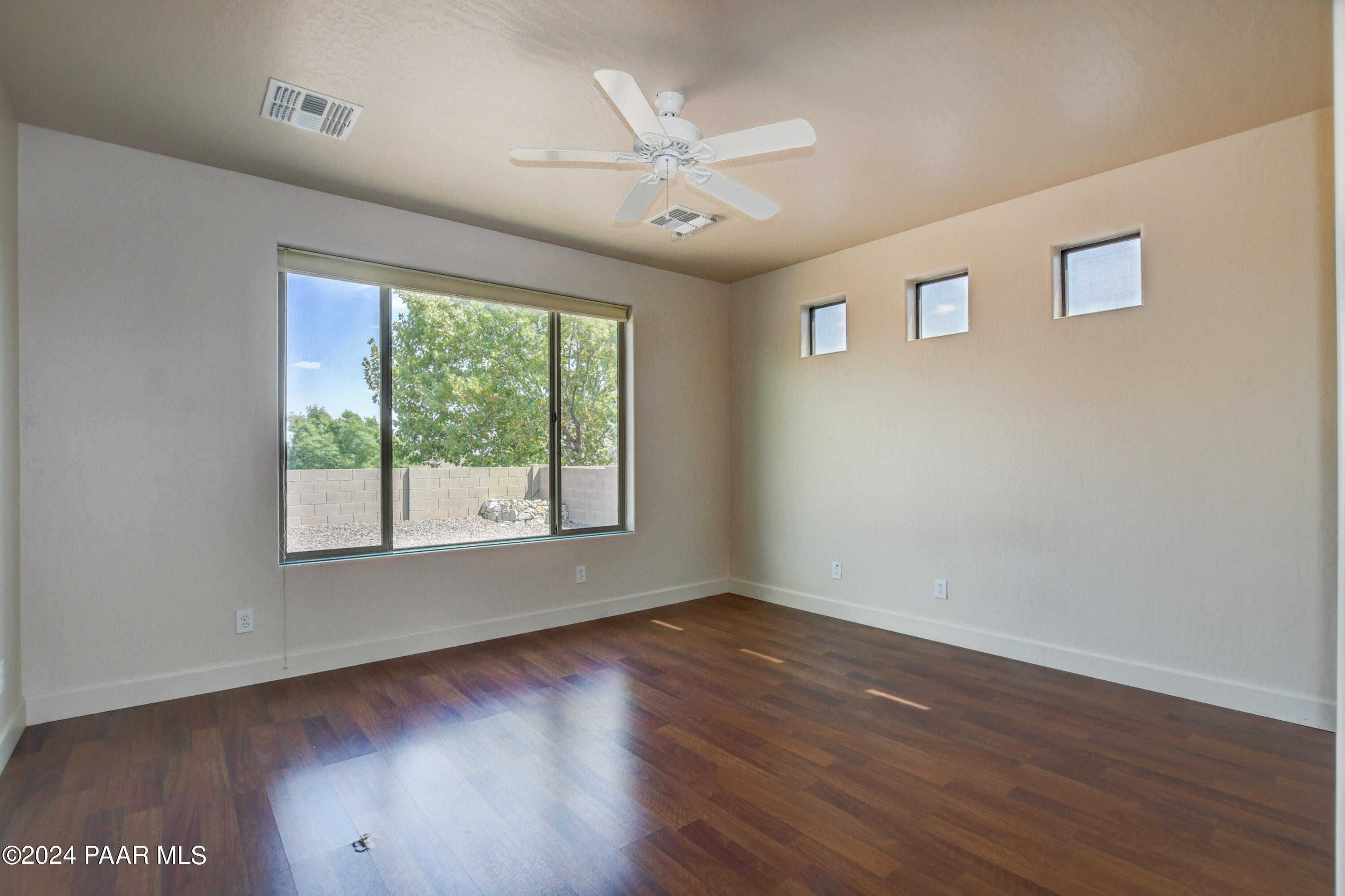 1147 Rusty Nail Road Prescott Valley, AZ 86314 - Photo 15 of 50 a view of an empty room with wooden floor and a window