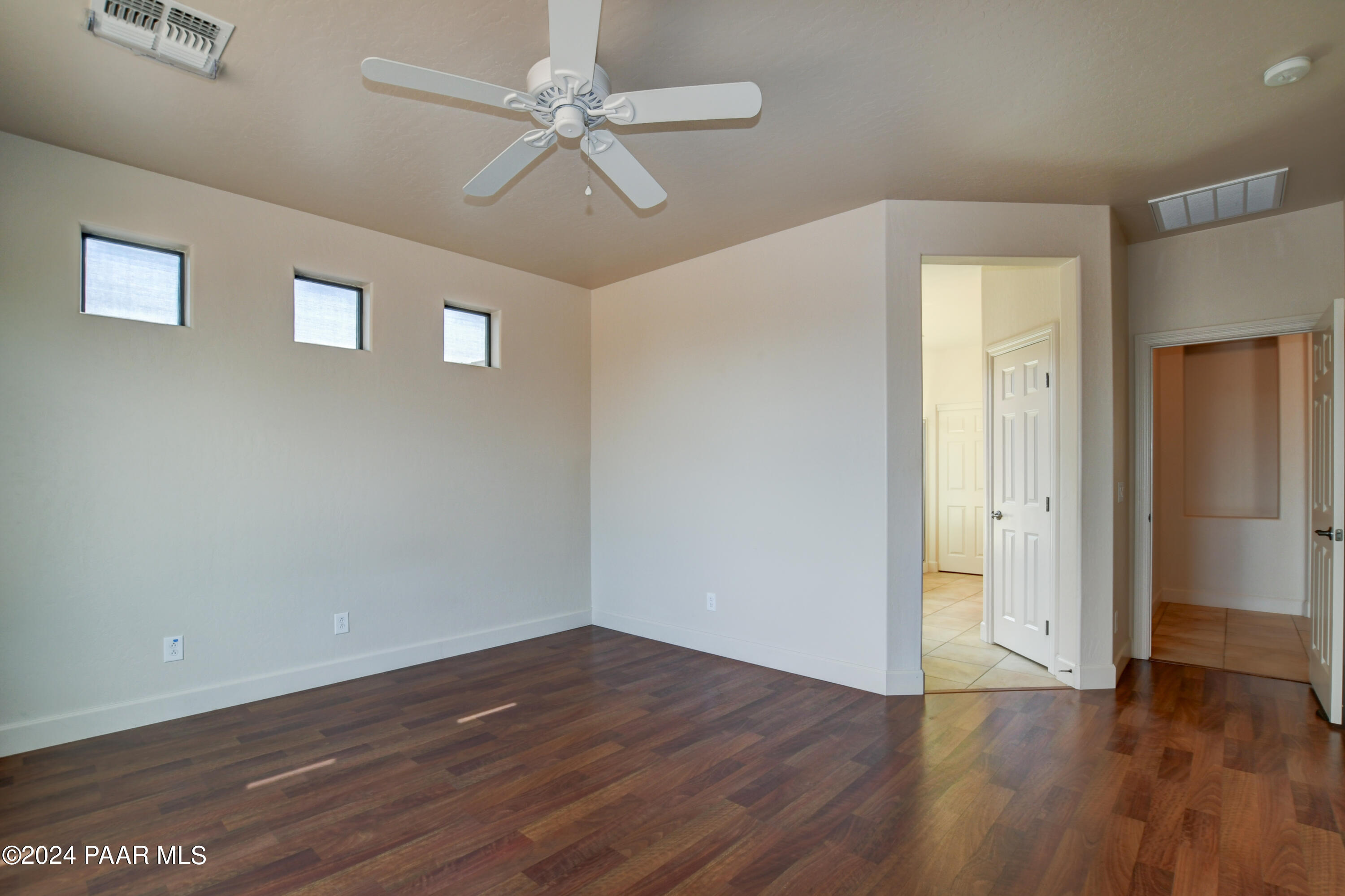 1147 Rusty Nail Road Prescott Valley, AZ 86314 - Photo 16 of 50 a view of an empty room with wooden floor