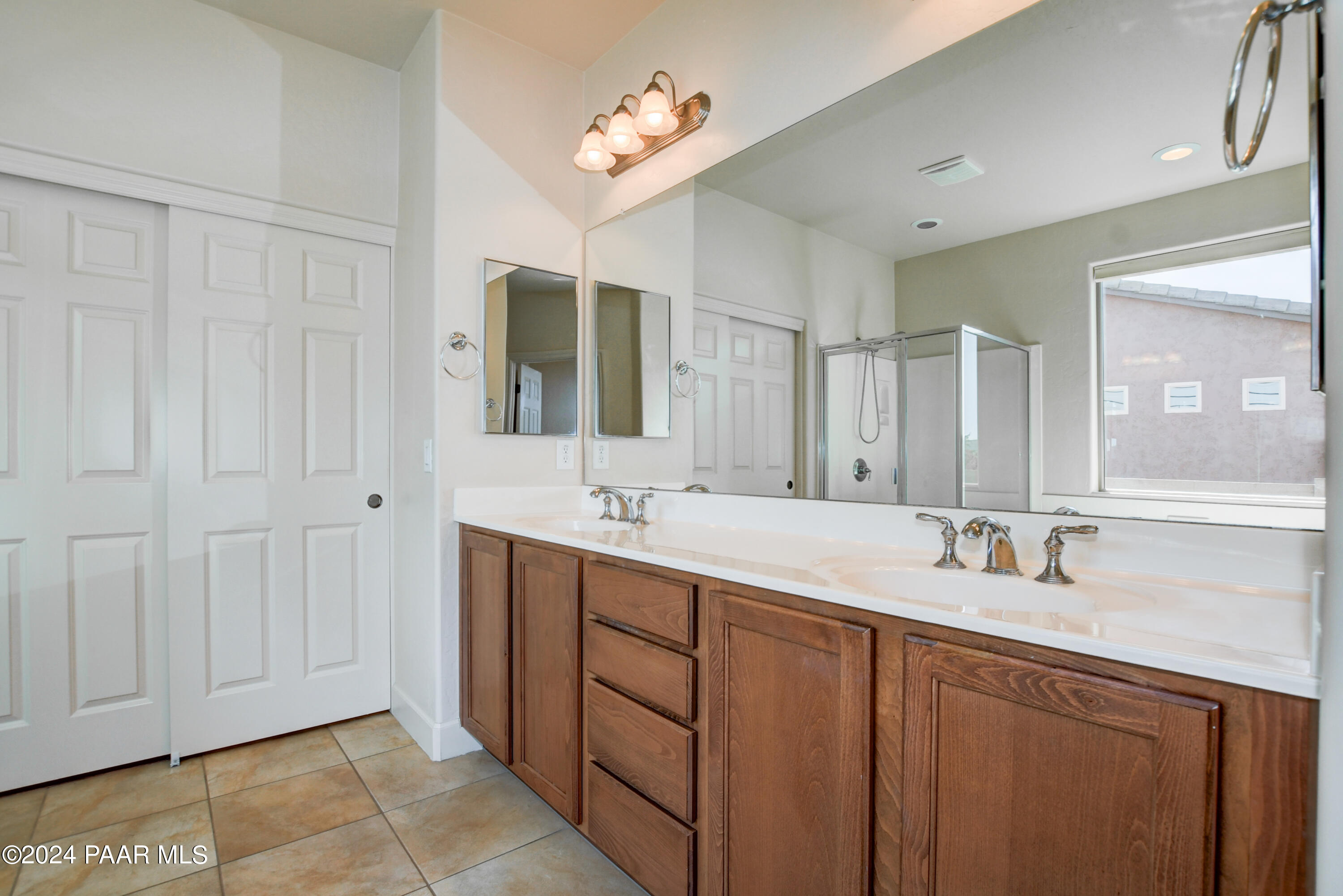 1147 Rusty Nail Road Prescott Valley, AZ 86314 - Photo 18 of 50 a bathroom with a double vanity sink and a mirror