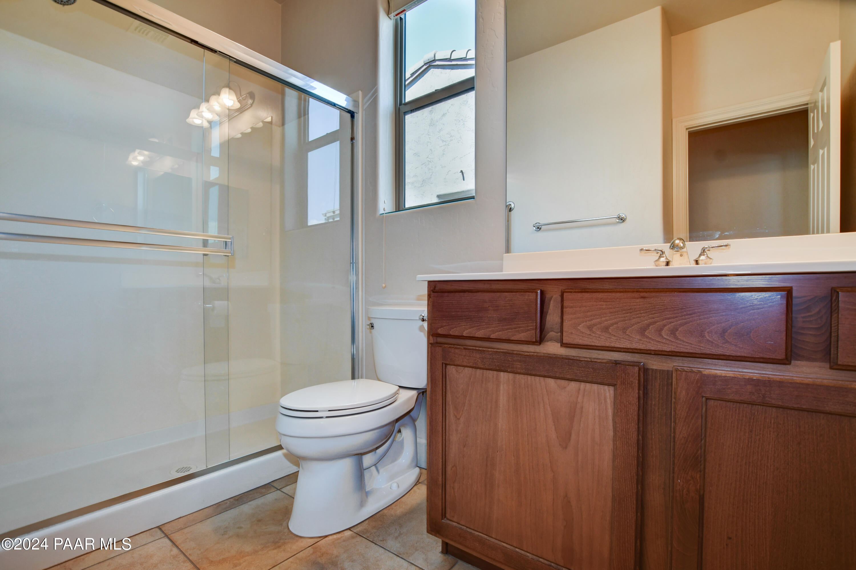 1147 Rusty Nail Road Prescott Valley, AZ 86314 - Photo 21 of 50 a bathroom with a sink a toilet and a mirror