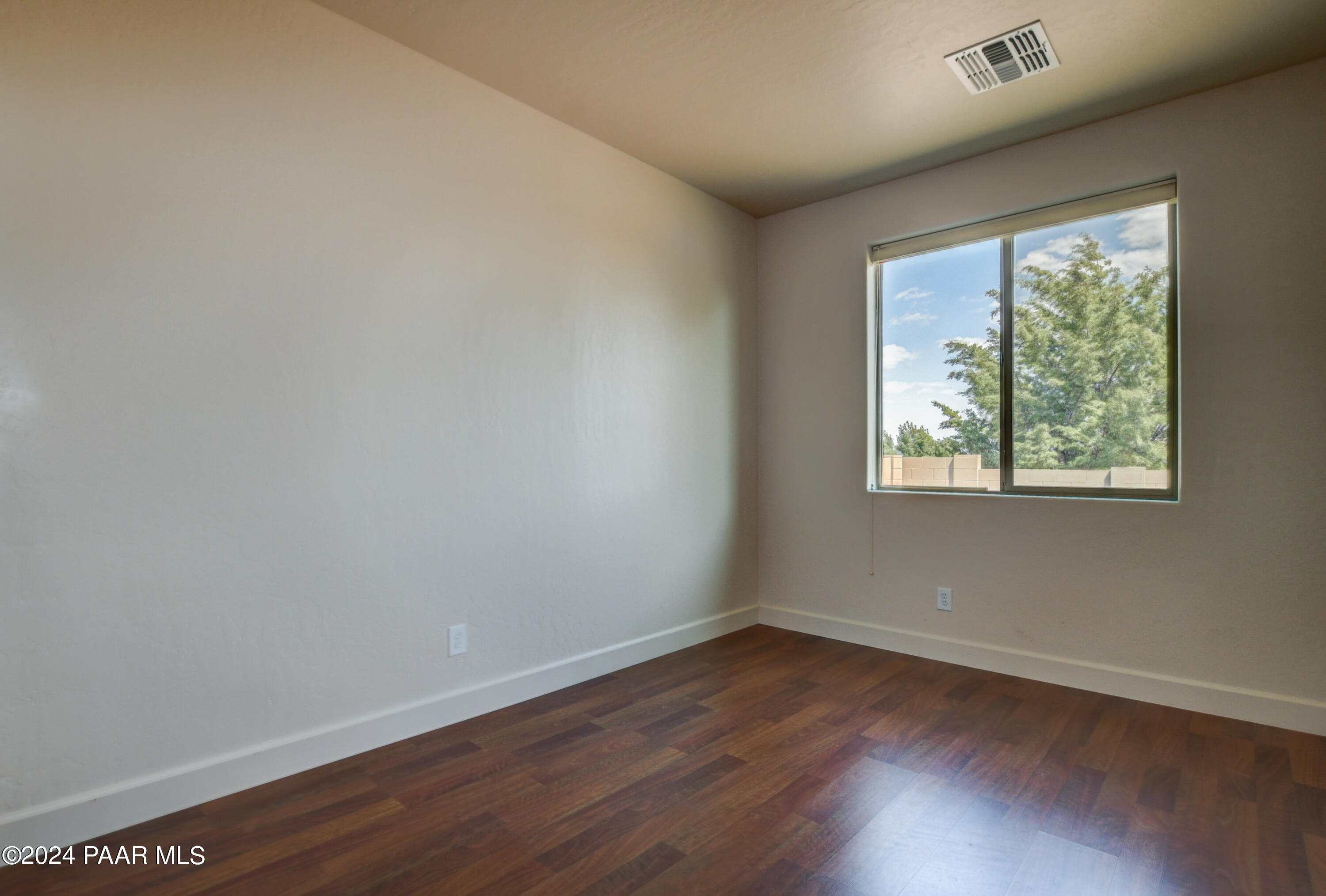 1147 Rusty Nail Road Prescott Valley, AZ 86314 - Photo 22 of 50 wooden floor in an empty room with a window