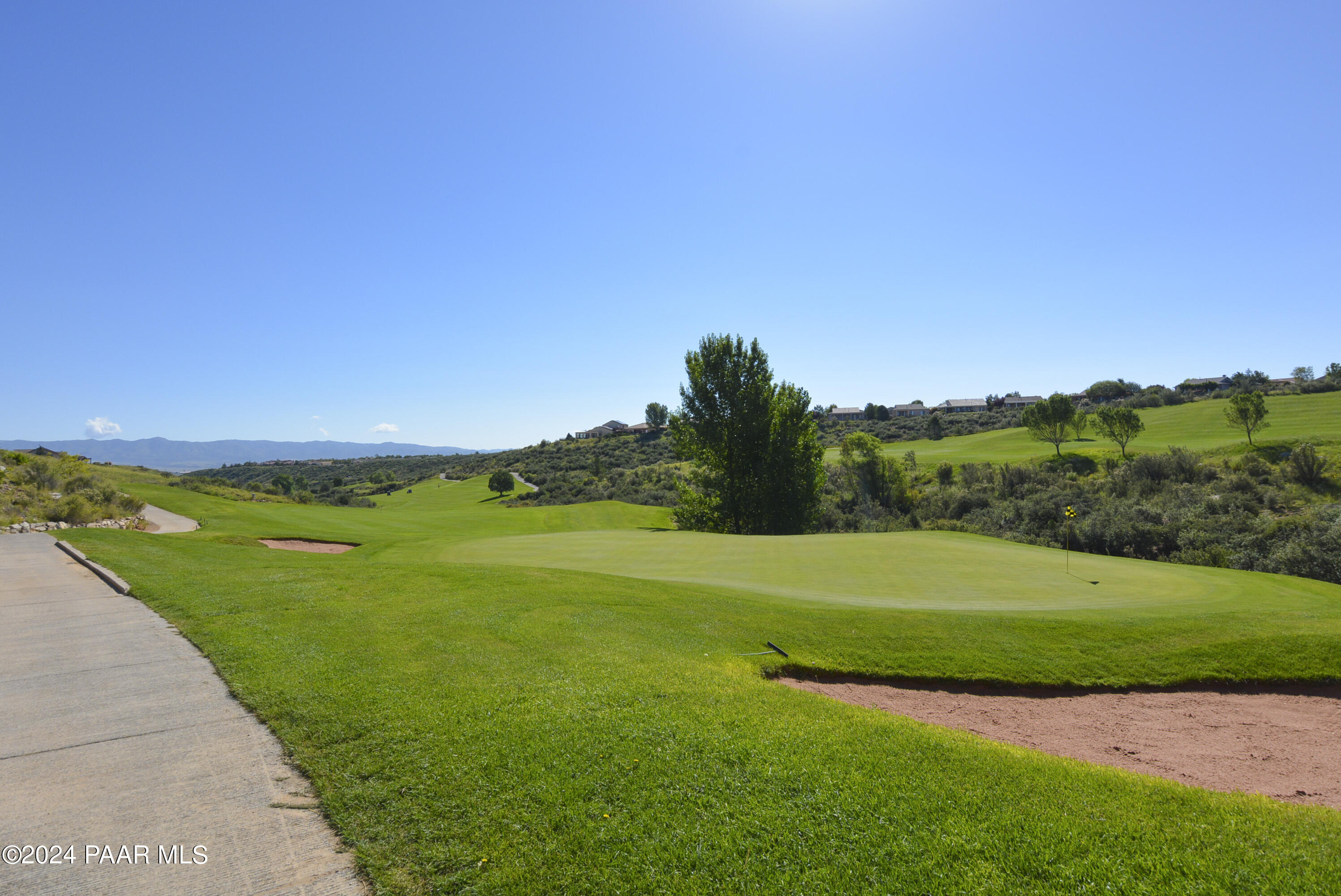 1147 Rusty Nail Road Prescott Valley, AZ 86314 - Photo 41 of 50 a view of a grassy field with an trees