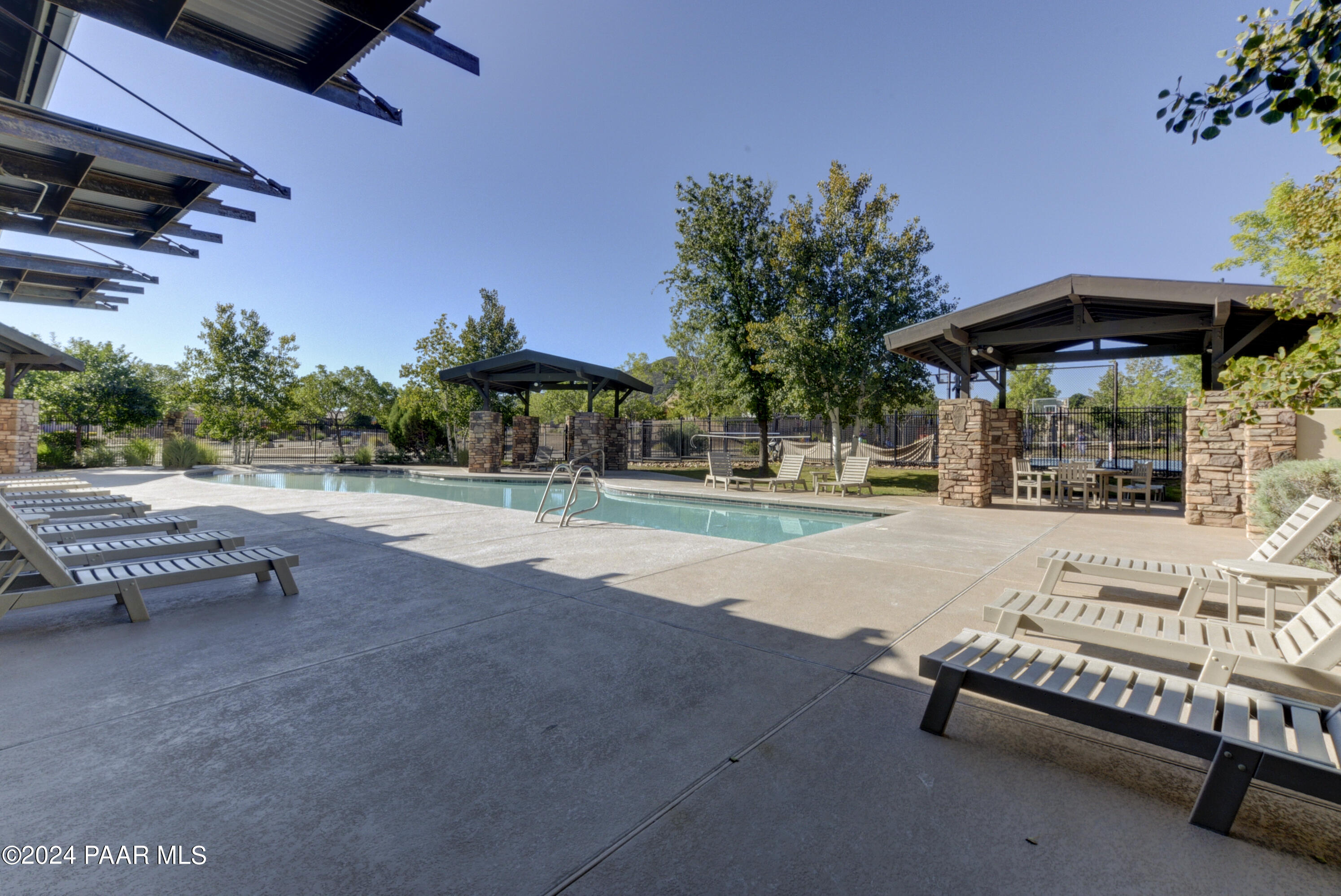 1147 Rusty Nail Road Prescott Valley, AZ 86314 - Photo 44 of 50 a view of a patio with a table and chairs under an umbrella