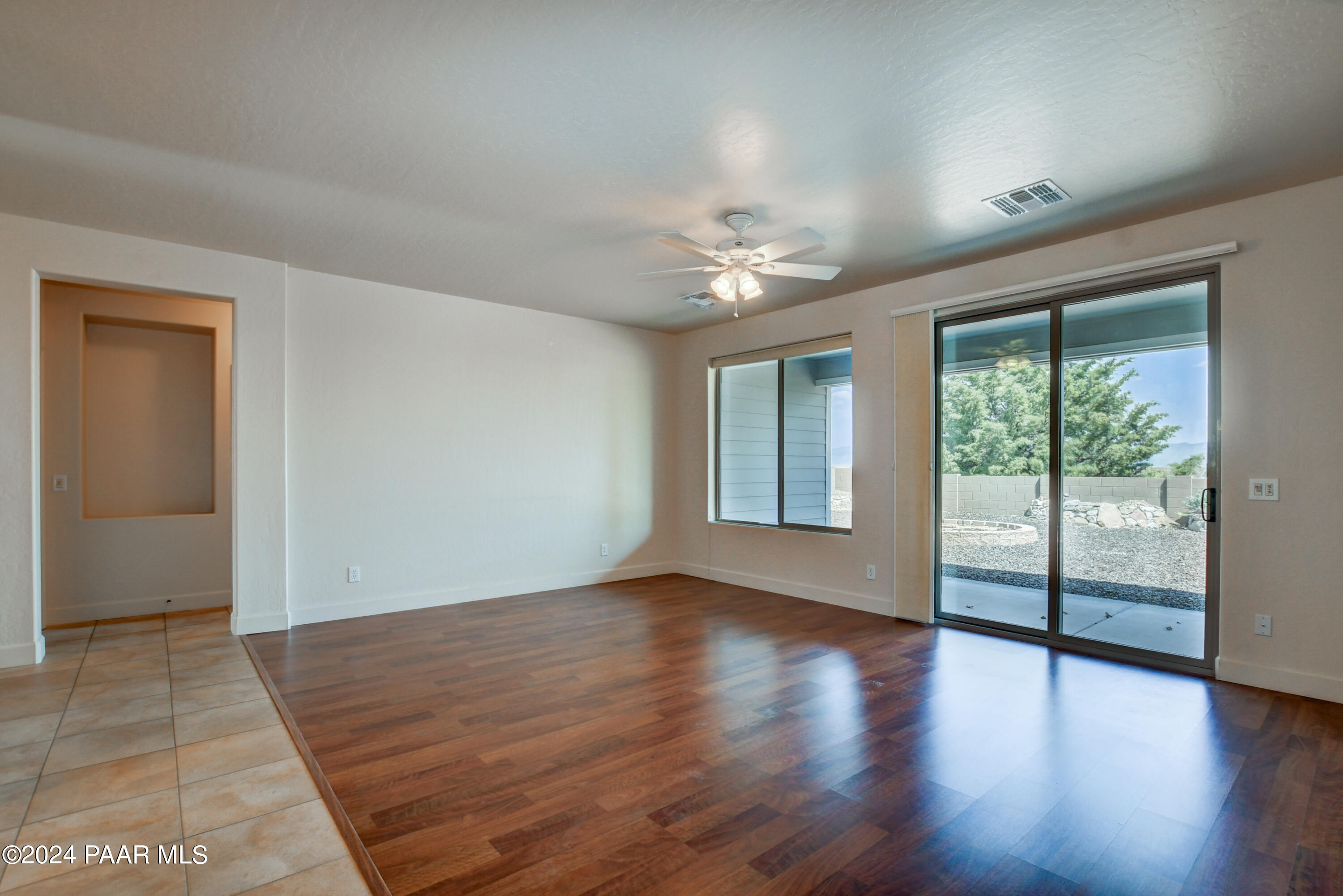 1147 Rusty Nail Road Prescott Valley, AZ 86314 - Photo 8 of 50 an empty room with wooden floor and windows