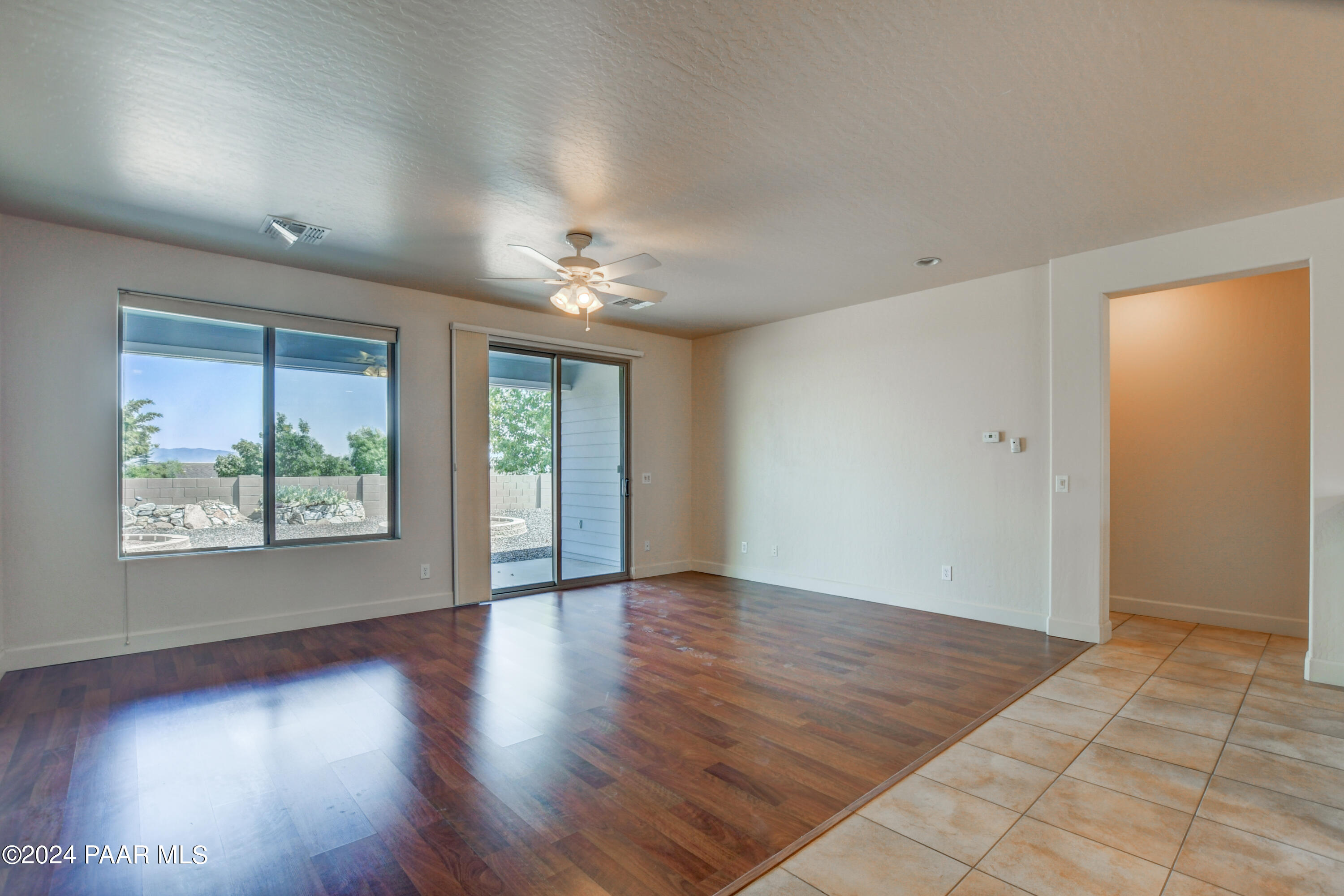 1147 Rusty Nail Road Prescott Valley, AZ 86314 - Photo 9 of 50 an empty room with wooden floor and windows