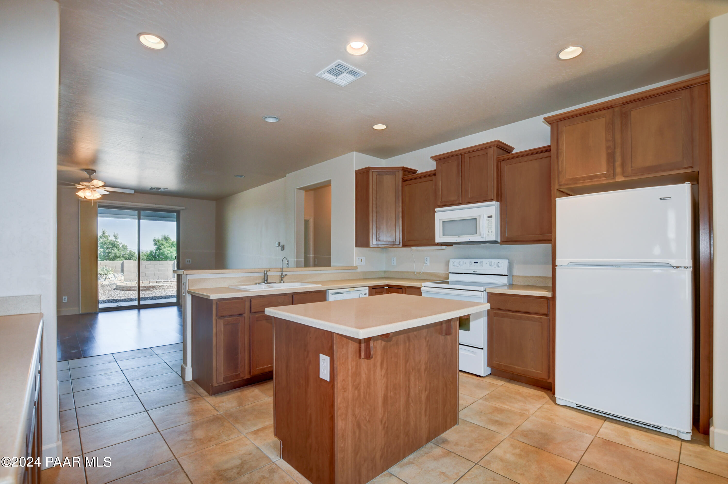 1147 Rusty Nail Road Prescott Valley, AZ 86314 - Photo 10 of 50 a kitchen with a sink a stove a refrigerator and a cabinets