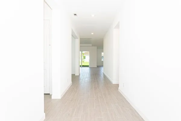 a view of a hallway with wooden floor