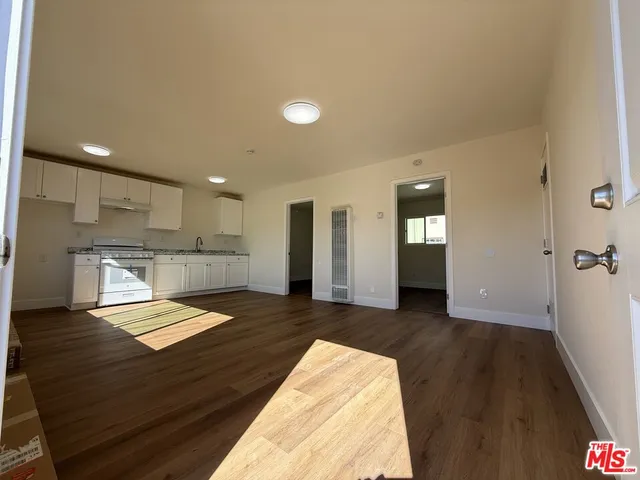 a view of kitchen with refrigerator and windows