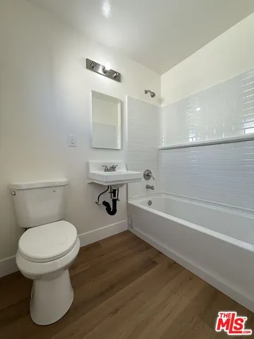 a bathroom with a toilet and a bathtub