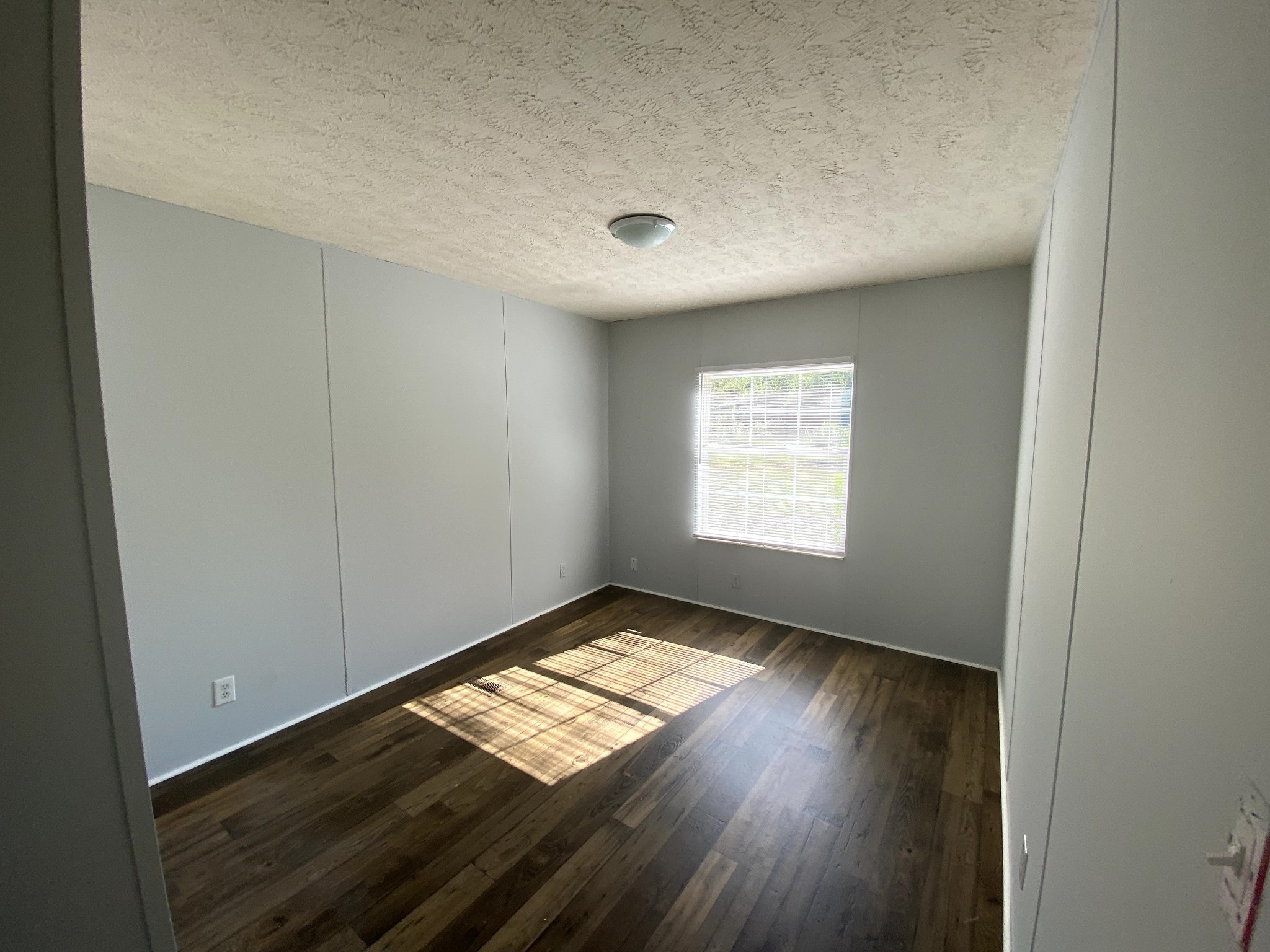 980 Mt Vernon Road Bethpage, TN 37022 - Photo 3 of 7 an empty room with wooden floor and windows