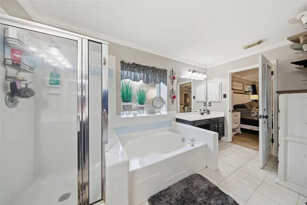 a large white kitchen with a tub and shower