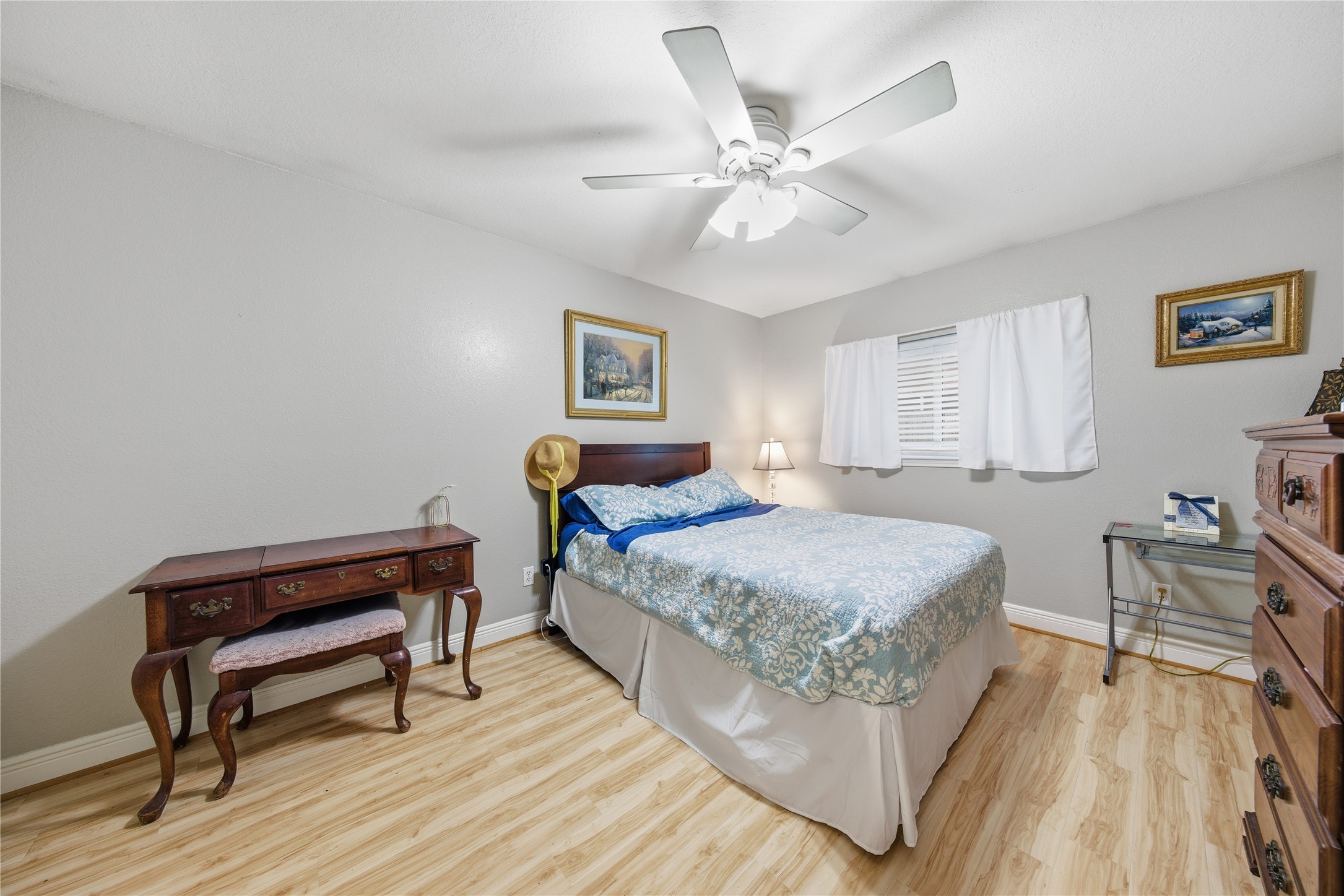 13506 Spring Court Tomball, TX 77375 - Photo 21 of 30 a bedroom with a bed and a chandelier