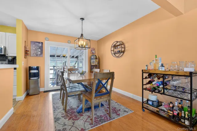 a dining room with furniture and wooden floor