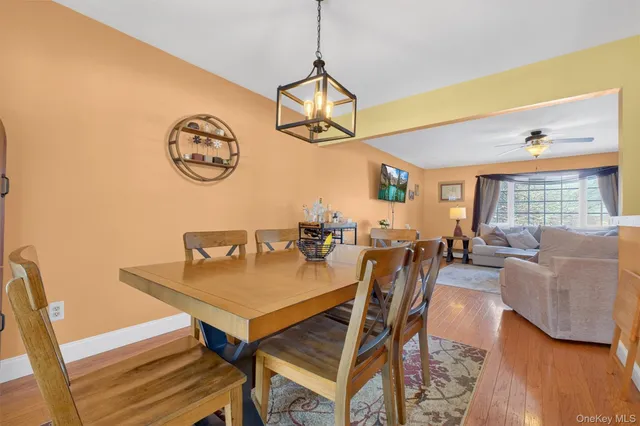 a view of a dining room with furniture and a chandelier