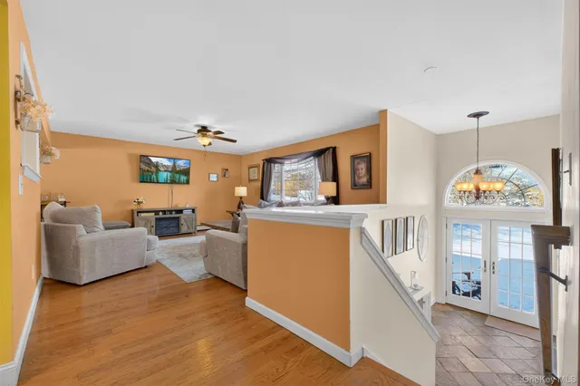a living room with furniture ceiling fan and a window