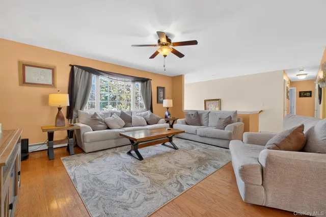 a living room with furniture and a view of kitchen