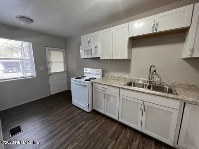 a kitchen with sink and cabinets