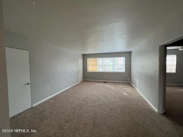 a view of an empty room and window