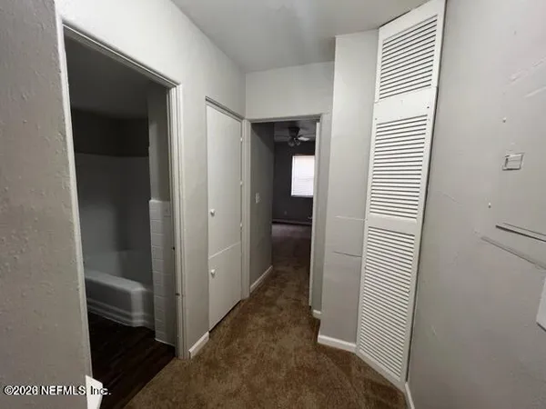 a view of a hallway with a room