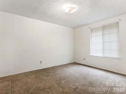 an empty room with a empty space and windows