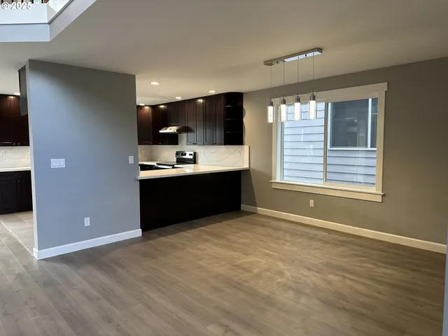 a view of kitchen with wooden floor and window