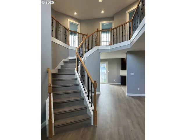 a view of entryway and hall with wooden floor