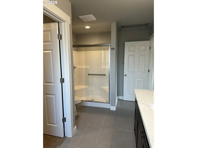 a view of an empty room with cabinet and entryway