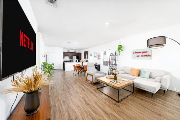 a living room with furniture and a flat screen tv