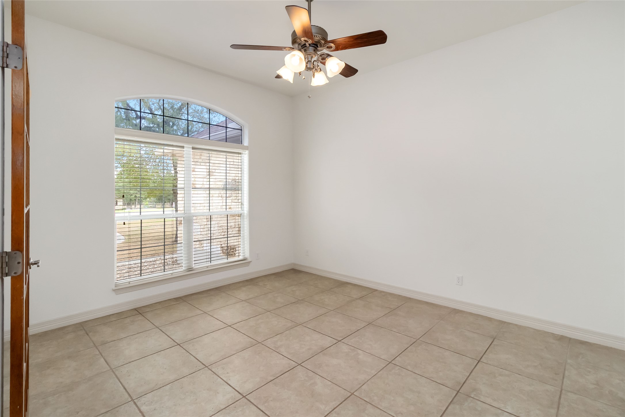 167 Winchester Road Bastrop, TX 78602 - Photo 16 of 34 Empty room with light tile patterned floors and ceiling fan
