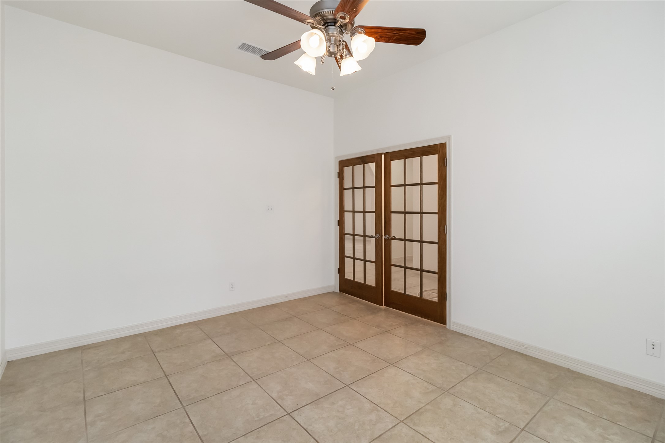 167 Winchester Road Bastrop, TX 78602 - Photo 17 of 34 Spare room featuring light tile patterned floors, ceiling fan, and french doors