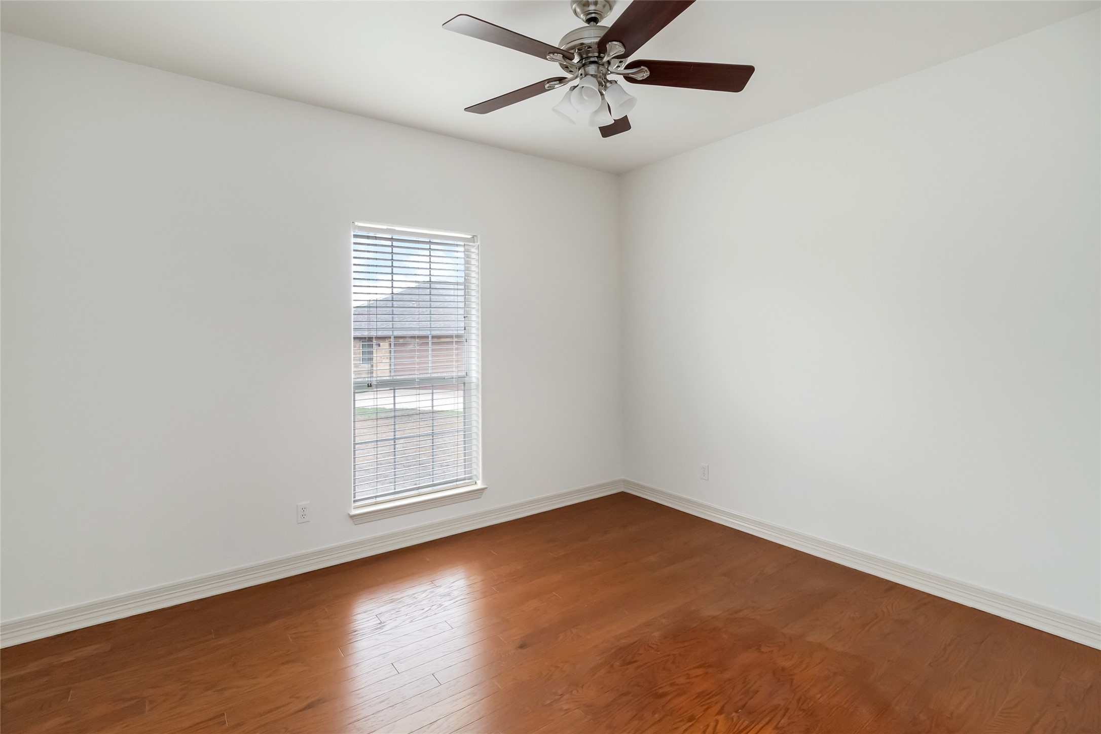 167 Winchester Road Bastrop, TX 78602 - Photo 22 of 34 Empty room with wood finished floors and a ceiling fan