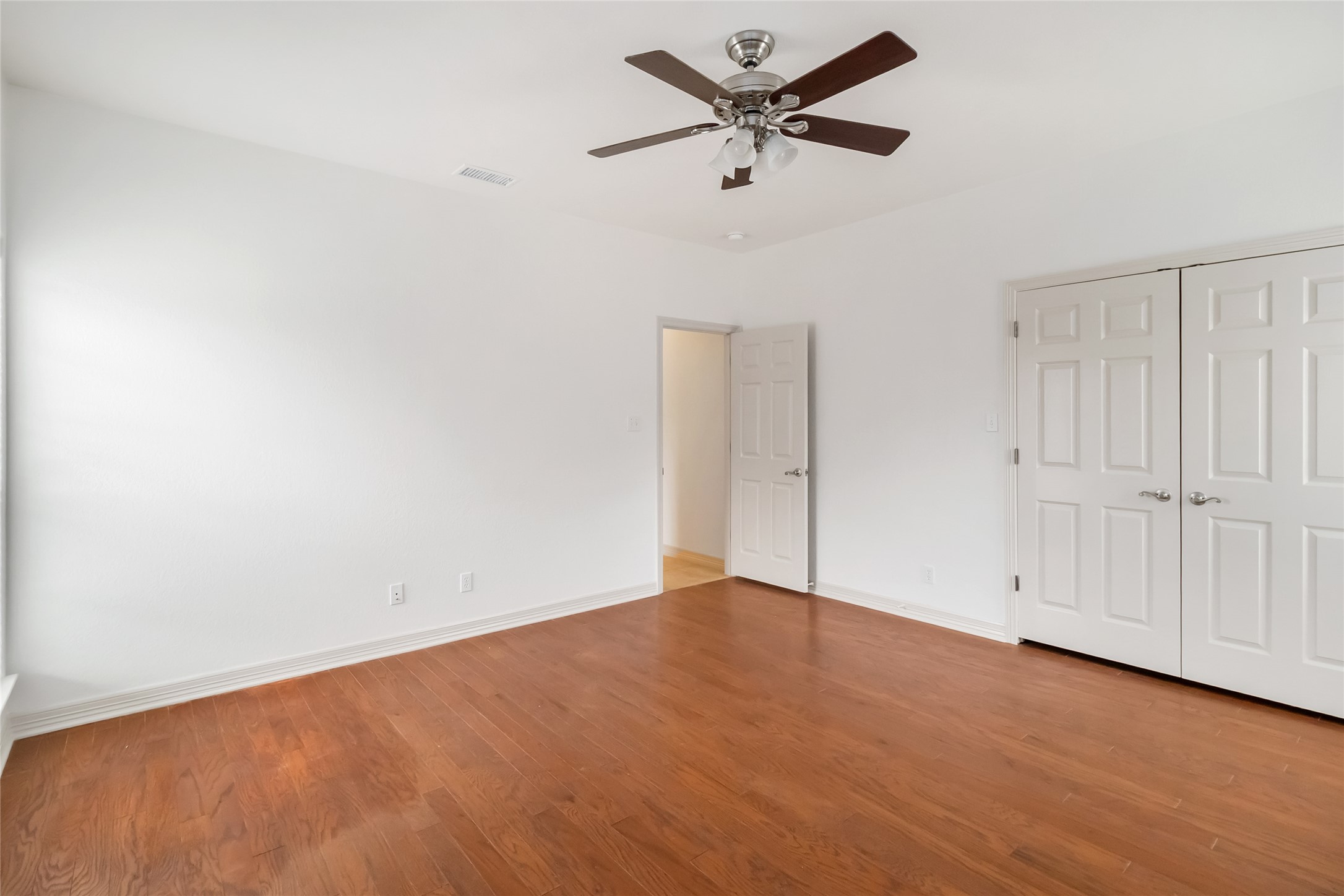167 Winchester Road Bastrop, TX 78602 - Photo 25 of 34 Unfurnished bedroom with light wood-style flooring, ceiling fan, and a closet
