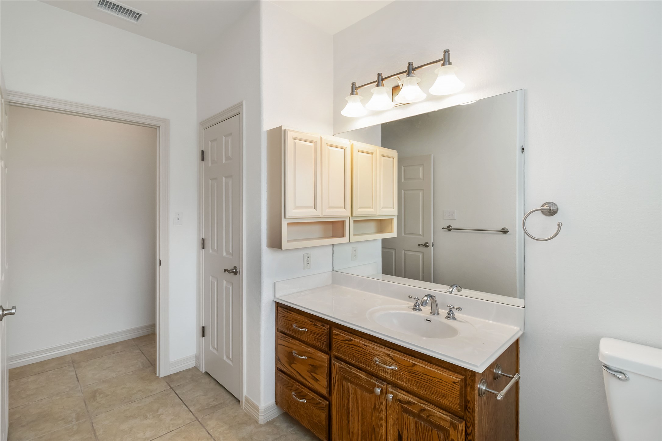 167 Winchester Road Bastrop, TX 78602 - Photo 27 of 34 Bathroom with vanity and light tile patterned flooring