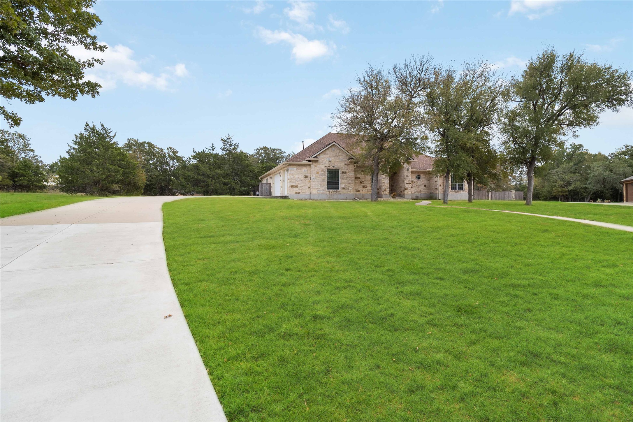 167 Winchester Road Bastrop, TX 78602 - Photo 7 of 34 View of front of home featuring brick siding, a front lawn, and concrete driveway