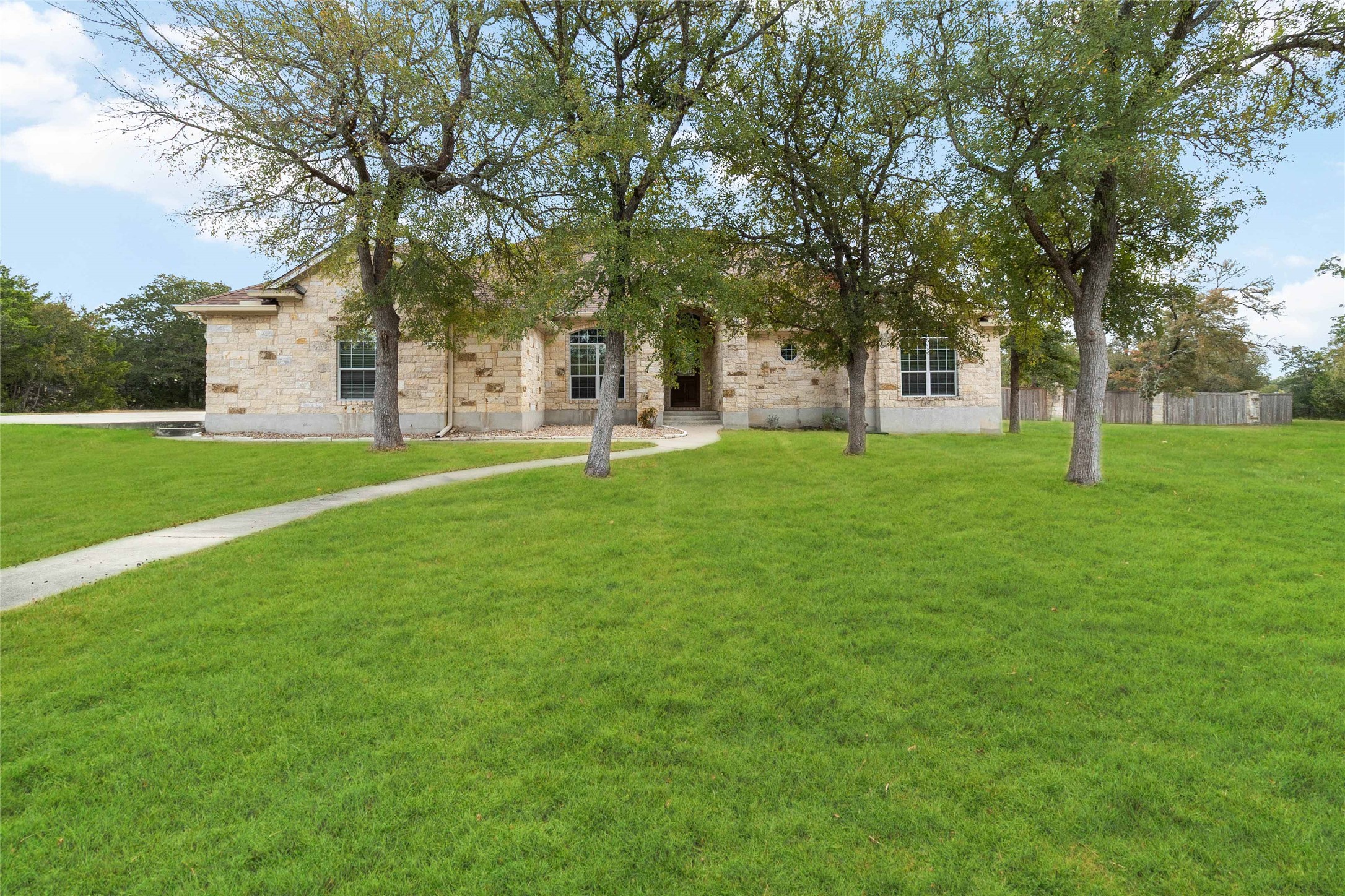 167 Winchester Road Bastrop, TX 78602 - Photo 8 of 34 Obstructed view of property featuring stone siding