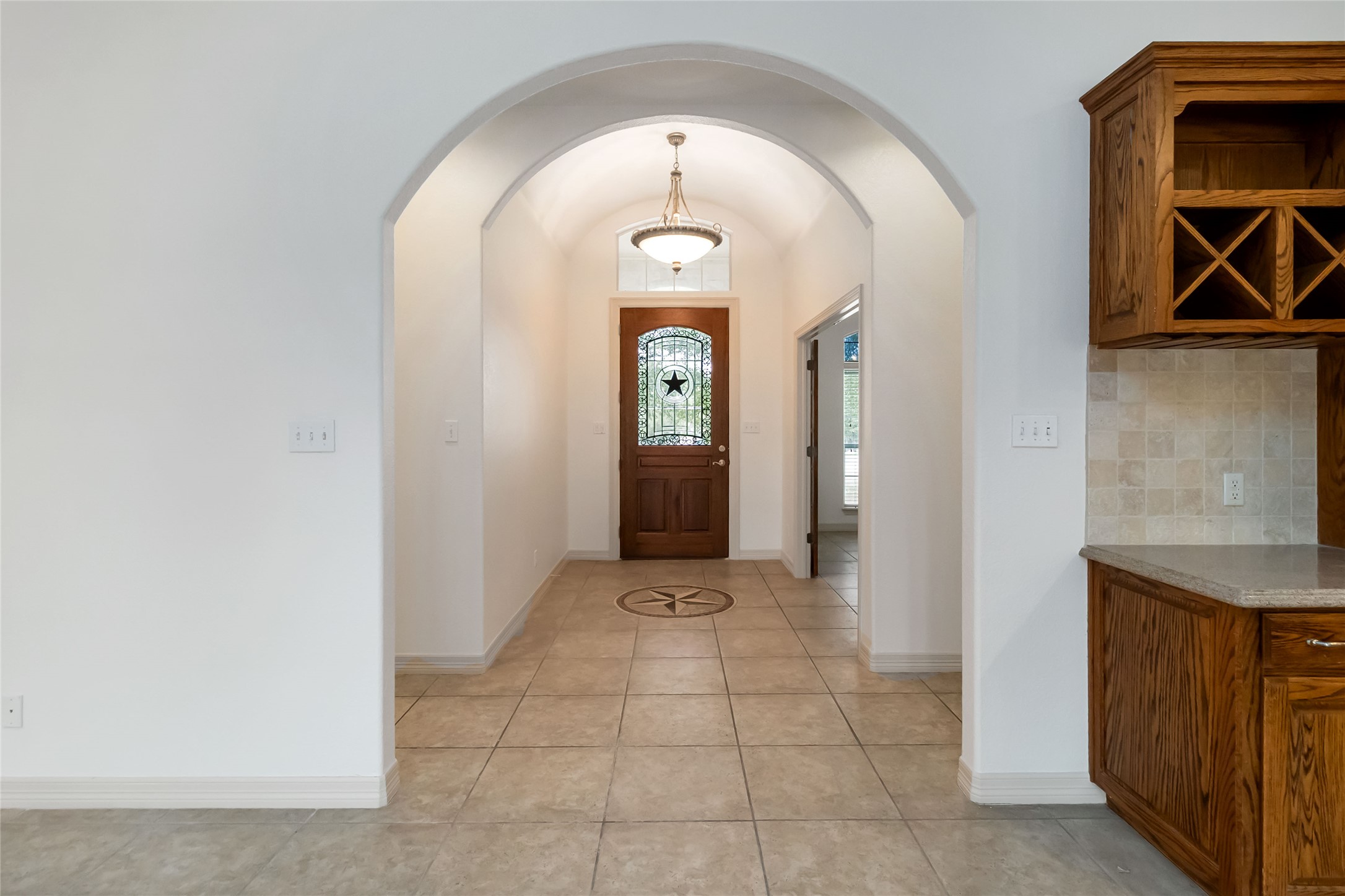 167 Winchester Road Bastrop, TX 78602 - Photo 9 of 34 Entrance foyer with light tile patterned flooring, vaulted ceiling, and arched walkways
