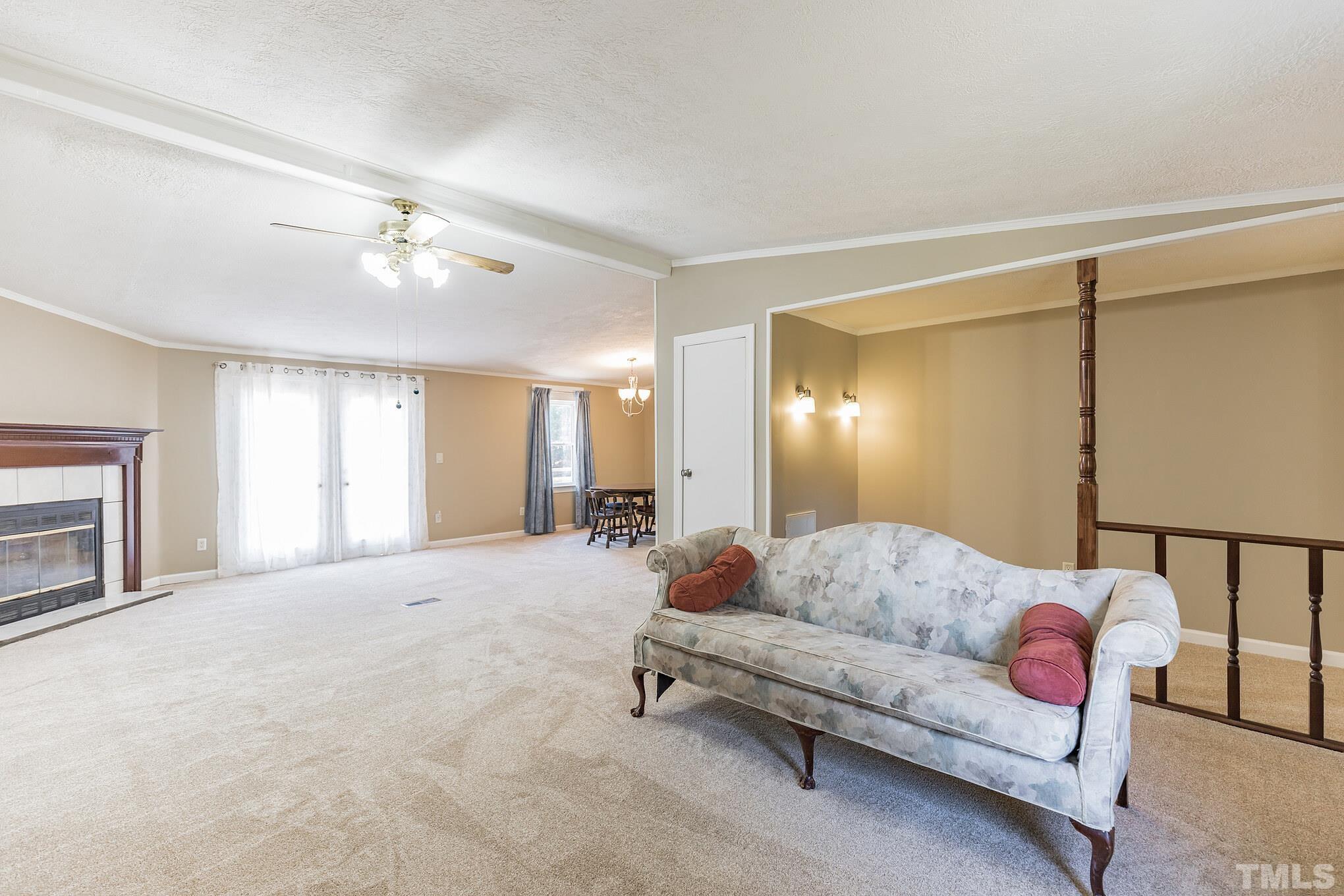 290 Thomas Cash Road Apex, NC 27523 - Photo 11 of 40 a living room with furniture and a fireplace