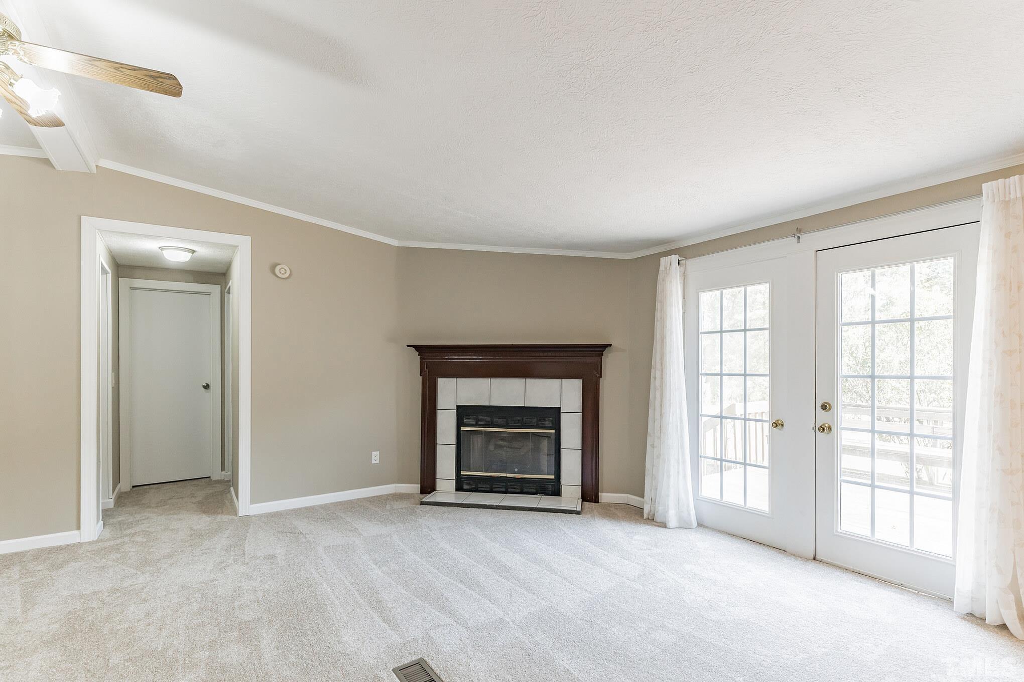 290 Thomas Cash Road Apex, NC 27523 - Photo 15 of 40 a view of an empty room with a window and fireplace