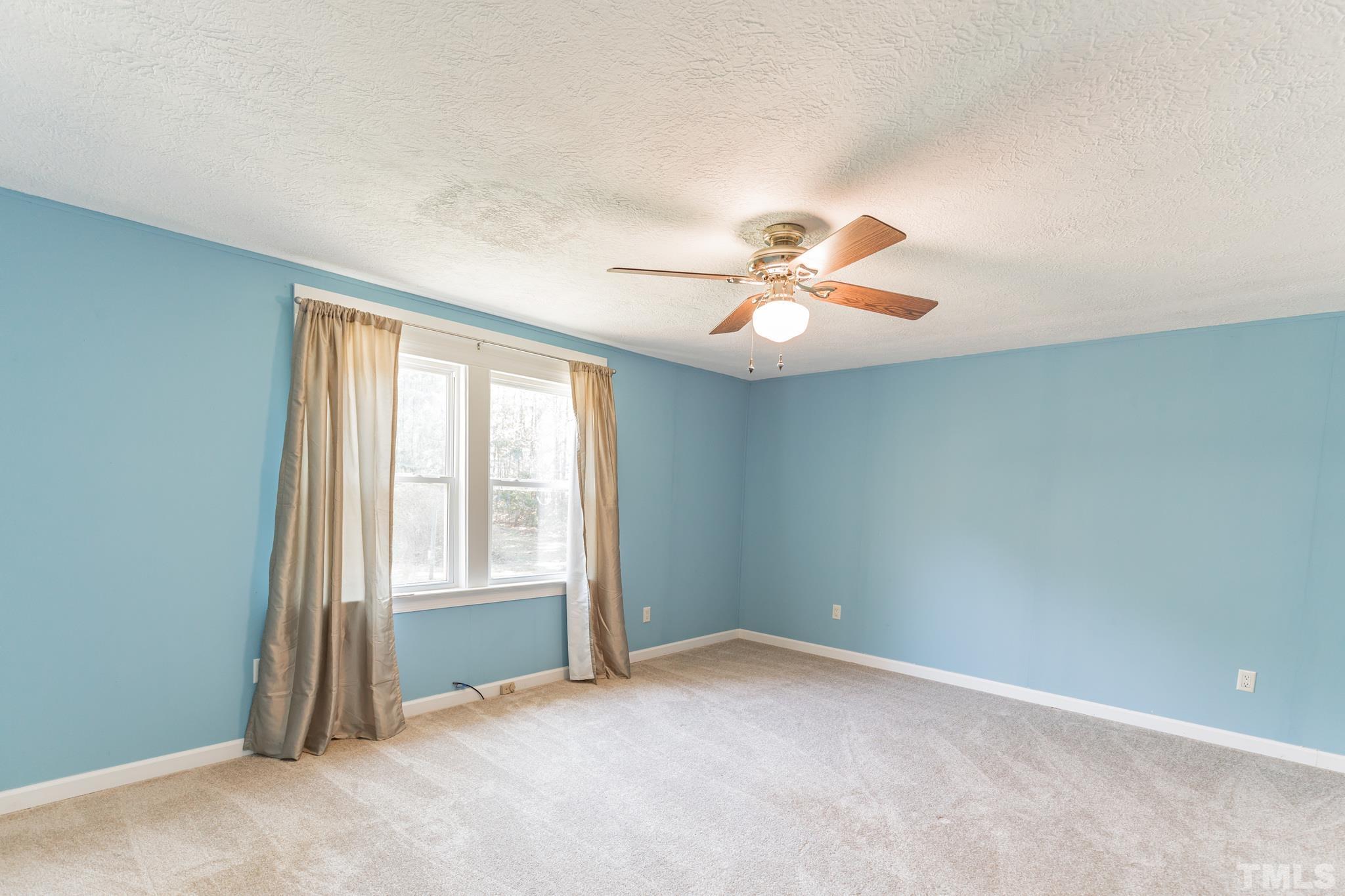 290 Thomas Cash Road Apex, NC 27523 - Photo 19 of 40 an empty room with fan and windows