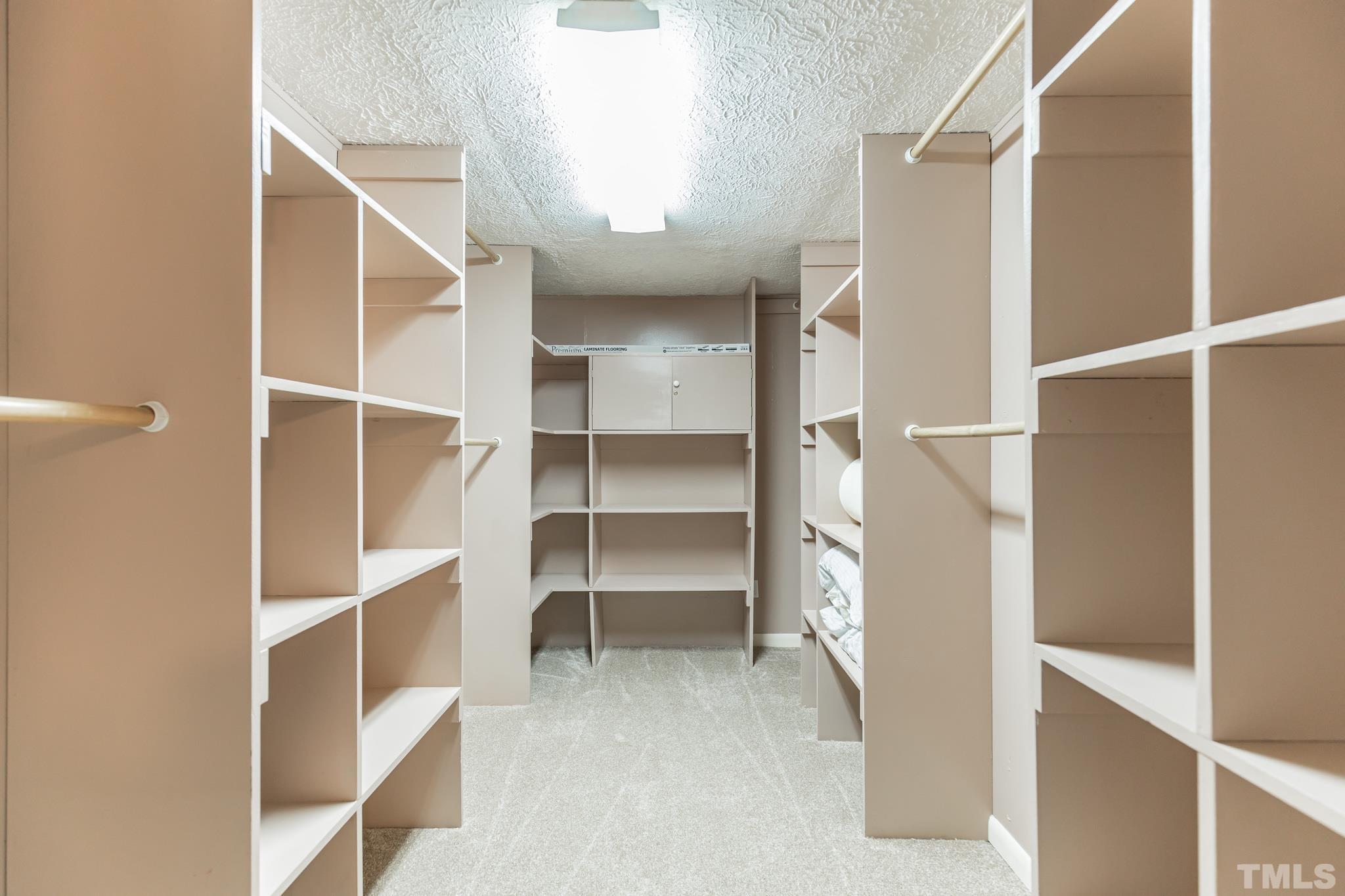 290 Thomas Cash Road Apex, NC 27523 - Photo 20 of 40 a view of walk in closet with empty racks