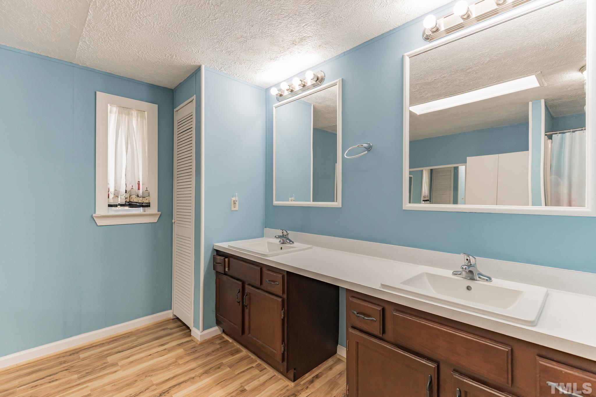 290 Thomas Cash Road Apex, NC 27523 - Photo 21 of 40 a bathroom with a double vanity sink and mirror
