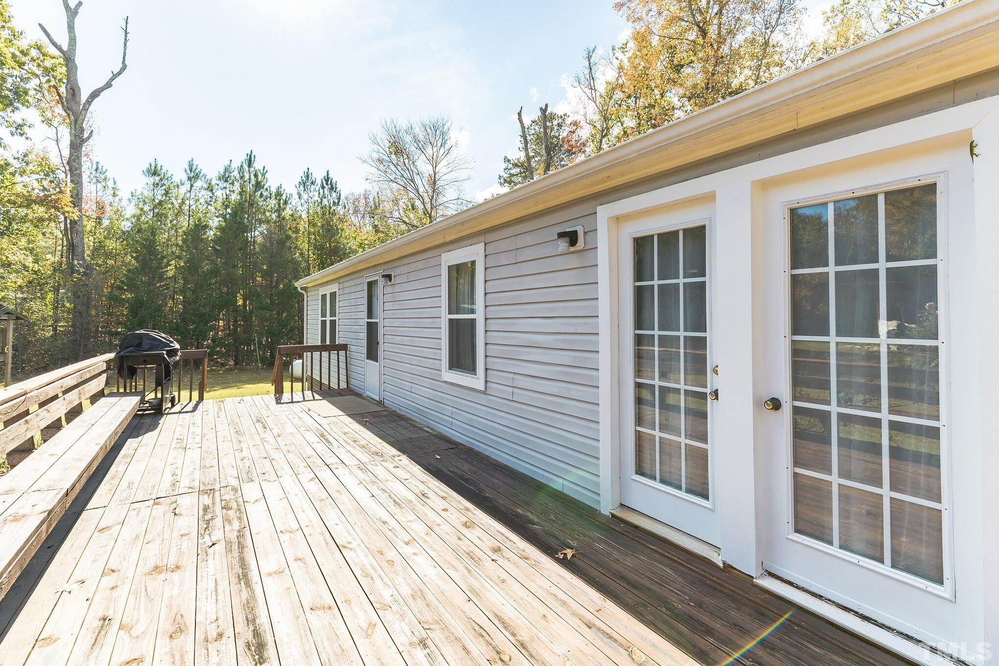 290 Thomas Cash Road Apex, NC 27523 - Photo 26 of 40 a view of a house with backyard and wooden floor