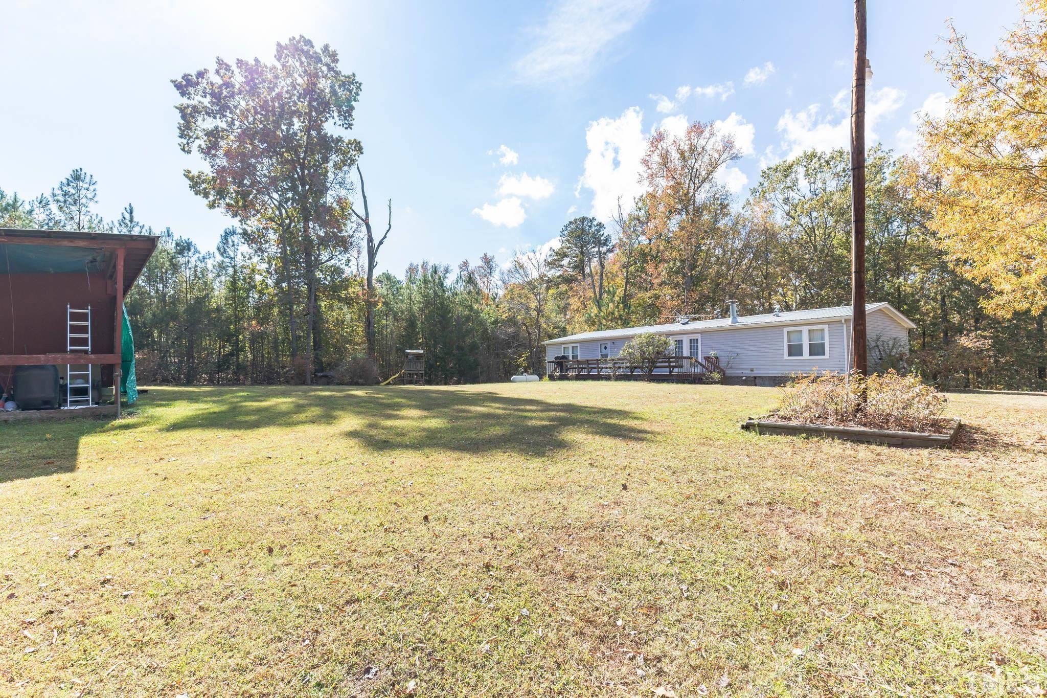 290 Thomas Cash Road Apex, NC 27523 - Photo 32 of 40 a view of a swimming pool with a house